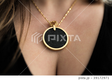 Chakra medallion hanging on the woman's neckline 39172971