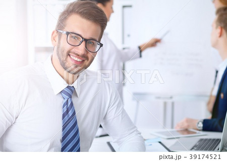Business people at meeting in office. Focus at 39174521