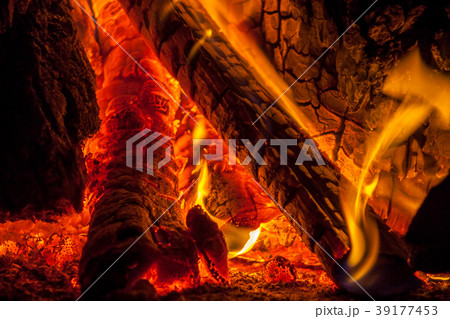 A fire burns in a fireplace A fire burns in a fireplace 39177453