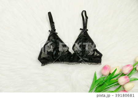 Black lace bodice and bouquet of tulips. Close up Black lace bodice and bouquet of tulips. Close up 39180681