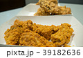 Fried chicken in white cardboard box on table. 39182636