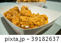 Fried chicken in white cardboard box on table. 39182637