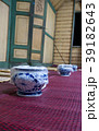 Old colorful thai vase on wood floor. 39182643