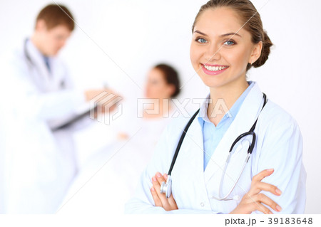 Cheerful smiling female doctor on the background Cheerful smiling female doctor on the background 39183648