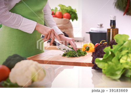 Close Up of human hands cooking vegetable salad in 39183669