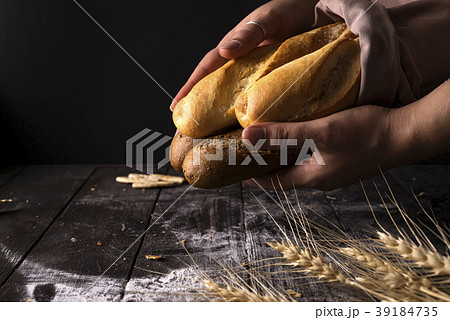 Baker woman holding rustic organic loaf of bread 39184735
