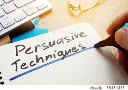 Man writing Persuasive Techniques in a note. Man writing Persuasive Techniques in a note. 39184863