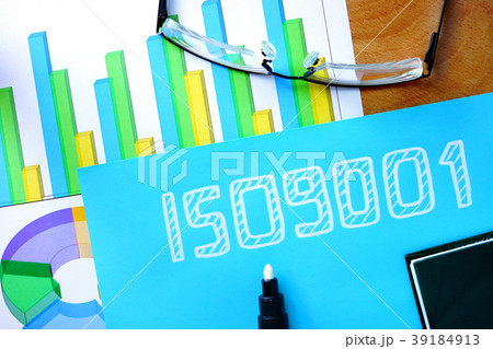 Blue paper with word iso 9001 and glasses. 39184913