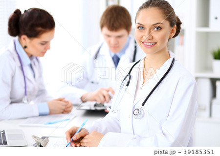 Happy female doctor keeping medical clipboard 39185351