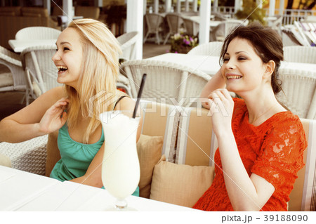 portrait of two pretty modern girl friends in cafe portrait of two pretty modern girl friends in cafe 39188090