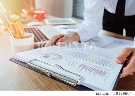 Businessman analyzing investment charts Businessman analyzing investment charts 39189664