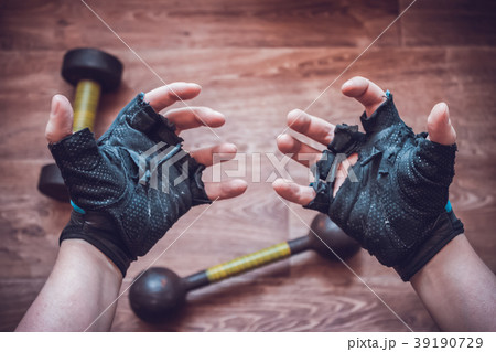 Hands of a man in torn sport gloves 39190729