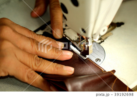Old women hand made sewing machine textile factory 39192698