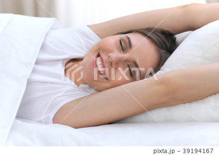 Beautiful young and happy woman sleeping while 39194167