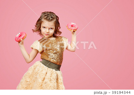 Little girl in dress with donuts Little girl in dress with donuts 39194344