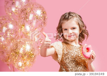 Girl holding donut and gesturing thumb up 39194349