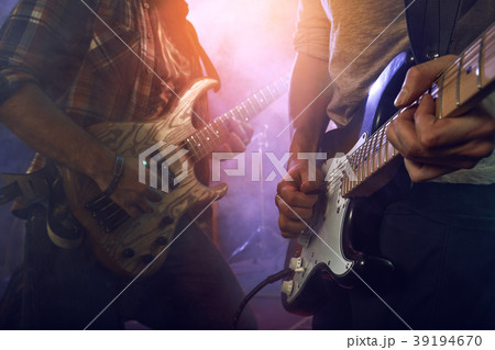 The musician plays an acoustic guitar. Scene 39194670