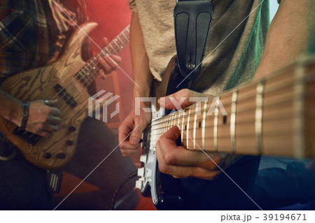 The musician plays an acoustic guitar. Scene 39194671