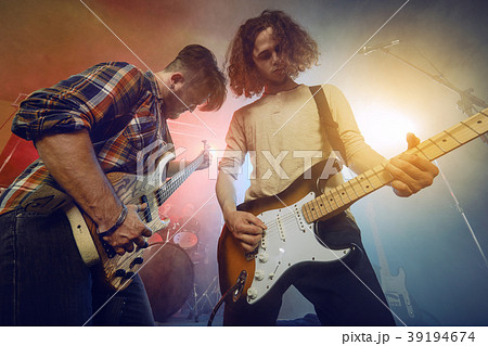 The musician plays an acoustic guitar. Scene 39194674