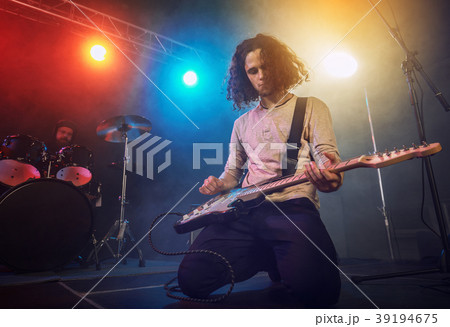 The musician plays an acoustic guitar. Scene 39194675