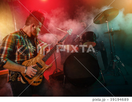 The musician plays an acoustic guitar. Scene 39194689