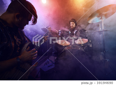 The musician plays an acoustic guitar. Scene 39194690