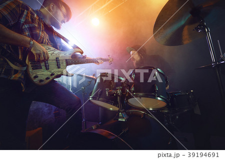 The musician plays an acoustic guitar. Scene 39194691