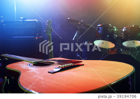 The musician plays an acoustic guitar. Scene 39194706