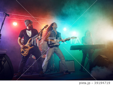 The musician plays an acoustic guitar. Scene The musician plays an acoustic guitar. Scene 39194719