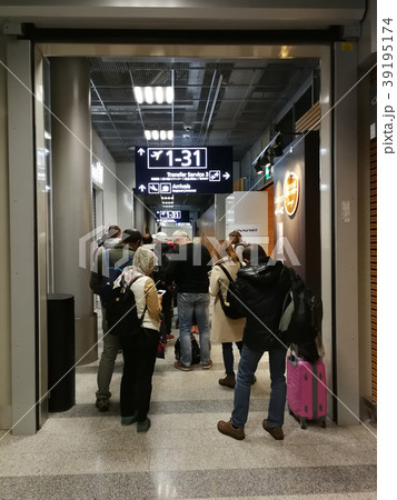 Passengers standing in the row at Finland airport. Passengers standing in the row at Finland airport. 39195174