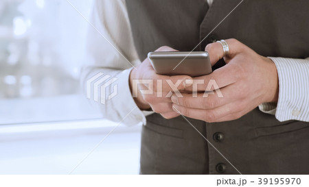Male student standing by window and texting from 39195970