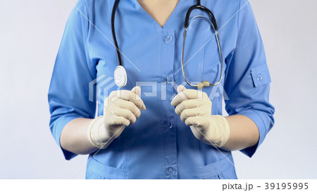 Medical worker in uniform and rubber gloves 39195995