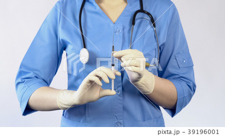 Woman doctor holding syringe going to make an 39196001