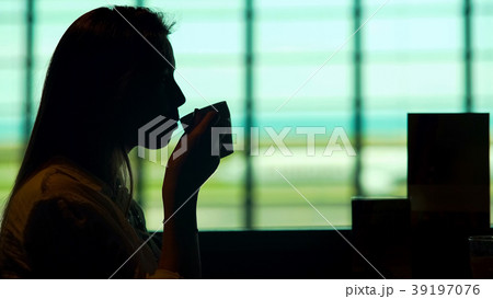 Beautiful woman waiting for plane at airport 39197076