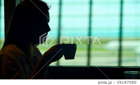 Young lady sitting at airport restaurant and 39197080