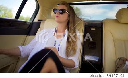 Beautiful independent woman enjoying car trip on 39197101