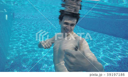 Happy man showing thumbs up under water, swimming 39197186