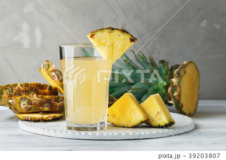 Pineapple fresh juice in glass on a wooden table Pineapple fresh juice in glass on a wooden table 39203807