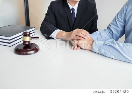Image of Male lawyer or judge help encourage client, customer, w Image of Male lawyer or judge help encourage client, customer, w 39204420