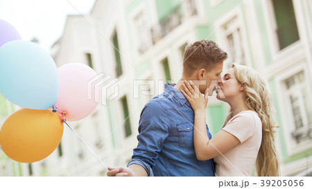 Sweet couple kissing in street, romantic date with 39205056