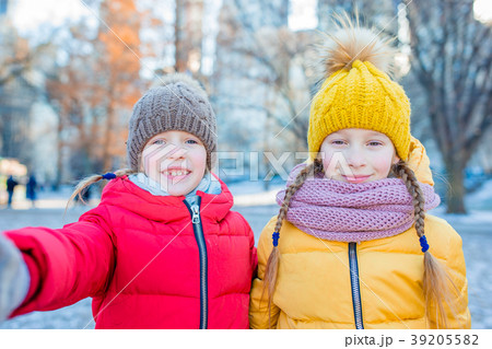 Adorable little girls taking selfie photo in 39205582