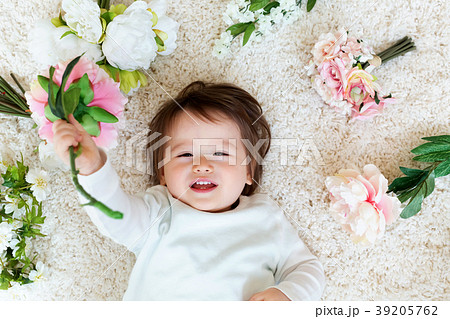 Happy toddler boy with spring flowers Happy toddler boy with spring flowers 39205762