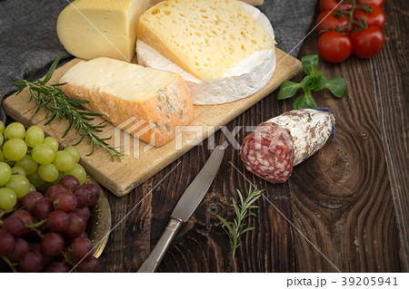 Cheeses with rosemary, tomatoes, grapes and salame Cheeses with rosemary, tomatoes, grapes and salame 39205941