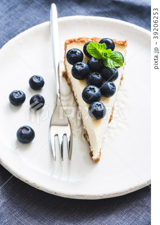 Cheesecake with fresh blueberries on white plate 39206253