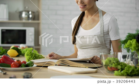 Asian female reading ingredients list for salad in Asian female reading ingredients list for salad in 39206443