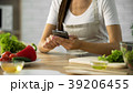 Woman choosing salad recipe on smartphone at the Woman choosing salad recipe on smartphone at the 39206455