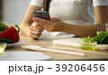 Close-up of female hands scrolling on smartphone Close-up of female hands scrolling on smartphone 39206456