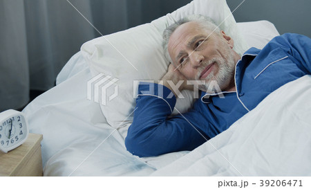Senior male waking up and smiling after Senior male waking up and smiling after 39206471