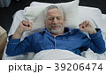 Pensioner stretching in his bed after awakening in Pensioner stretching in his bed after awakening in 39206474