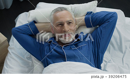 Man basking in bed rejoicing at new orthopedic 39206475